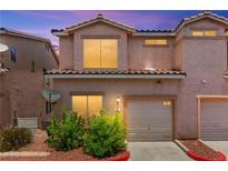 Charming two-story townhome with an attached garage and well-maintained landscaping at 68 Belle Soleil Ave, Las Vegas, NV 89123