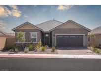 Charming single-story home featuring a two-car garage, desert landscaping, and a welcoming front porch at 817 Cottonwood Hill Pl, Henderson, NV 89011