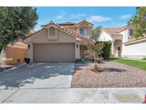 Charming home featuring a spacious two-car garage, well-kept landscaping, and a welcoming front entrance at 9449 Amber Valley Ln, Las Vegas, NV 89134