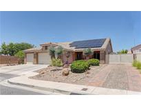 Charming single-story home featuring a well-maintained yard, brick driveway, three-car garage and solar panels at 950 Marbelwood Ave, Las Vegas, NV 89123