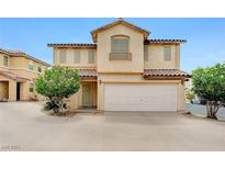 Inviting two-story home with a two car garage and lush landscaping in the front yard at 967 Coronado Peak Ave, Las Vegas, NV 89183
