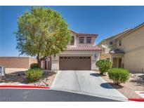 Charming two-story home with desert landscaping, driveway, and two car garage at 9746 Vista Cache Ct, Las Vegas, NV 89148