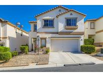 Charming two-story home with a well-manicured front yard, attached garage and desert landscaping at 10413 Rising Harbor Ave, Las Vegas, NV 89129