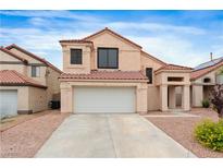 Charming home featuring a two-car garage, desert landscaping, and a red tile roof at 120 Wynntry Dr, Henderson, NV 89074