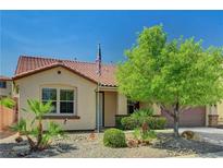 Charming single-story home showcasing desert landscaping, a red tile roof, and a welcoming entrance at 121 Staplehurst Ave, Henderson, NV 89002