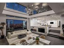 Bright, open living room featuring a fireplace, city views, and sleek, modern furnishings at 1491 Reims Dr, Henderson, NV 89012