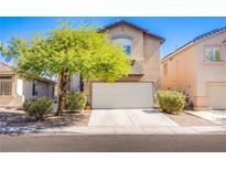 Charming two-story home with a well-manicured front yard and a two-car garage at 1844 Ghost Trace Ave, Las Vegas, NV 89183