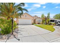 Inviting single-story home with a well-manicured lawn, complemented by a spacious driveway and desert landscaping at 2707 Wild Breeze Ct, North Las Vegas, NV 89031