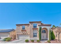 Charming two-story home featuring a well-maintained front yard and an attached two-car garage at 3525 Dover Bay St, Las Vegas, NV 89129