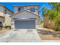 Charming two-story home with a neutral color palette, a gray garage door, and well-kept landscaping at 4118 Beech Family St, Las Vegas, NV 89115