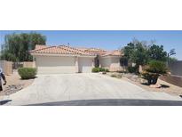 Charming single-story home with desert landscaping, a tile roof, and a three-car garage at 4904 Meadows Encore Ave, Las Vegas, NV 89131