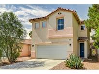 Two-story home featuring a two-car garage, desert landscaping, and a tile roof at 5004 Ironhorse Ranch Ave, Las Vegas, NV 89131