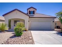 Charming single story home featuring a two-car garage and low-maintenance landscaping in front at 5240 Adorato Dr, North Las Vegas, NV 89031