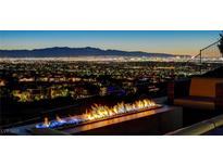 Breathtaking city view with fire pit, perfect for entertaining guests outdoors at night at 527 Serenity Point Dr, Henderson, NV 89012