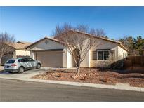 Charming single-story home featuring a low-maintenance desert landscaped front yard and a two-car garage at 5338 Lignum Ave, Pahrump, NV 89061