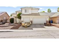 Two-story home featuring a three-car garage and low maintenance landscaping at 5539 Foxtail Ridge St, North Las Vegas, NV 89031