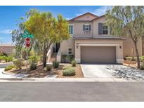 Charming two-story home with a two car garage, desert landscaping, and a covered front entrance at 7775 Santos Bay Ct, Las Vegas, NV 89179