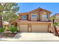 Charming two-story home featuring a well-maintained lawn and a two-car garage at 8229 Sedona Sunrise Dr, Las Vegas, NV 89128