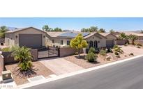 Stunning single-story home with a private gate, solar panels, and lush landscaping at 8713 Long Winter Ct, Las Vegas, NV 89131
