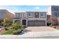 Charming home with well-kept landscaping, brick driveway, and a large three-car garage at 9883 Russian Hill St, Las Vegas, NV 89141