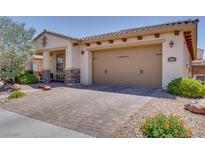Charming single-story home featuring a paver driveway and a two-car garage at 1000 Via Canale Dr, Henderson, NV 89011