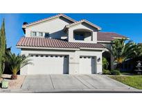 Charming two-story home with a three-car garage, desert landscaping, and a red tile roof at 10234 Renae Nicole Ct, Las Vegas, NV 89183