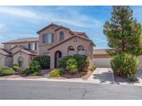 Charming two-story home with desert landscaping, a tile roof, and an attached two car garage at 10454 Gunpowder Falls St, Las Vegas, NV 89183