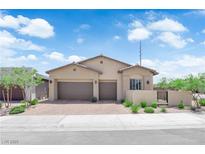 Charming single-story home featuring a three-car garage, desert landscaping, and a tile roof at 11909 Pippa Ave, Las Vegas, NV 89138