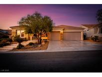 Beautiful home featuring a landscaped front yard, stone accents, large driveway, and a 3-car garage at 1744 Williamsport St, Henderson, NV 89052