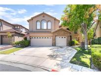 Charming two-story home featuring a three-car garage, stone accents, and a well-manicured front lawn at 259 Rockwell Springs Ct, Henderson, NV 89012