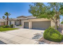 Charming single-story home featuring a three-car garage and well-manicured landscaping at 324 Quiet Harbor Dr, Henderson, NV 89052