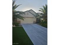 Well-maintained single-story home with palm trees and a spacious driveway at 5717 Blizzard Breeze St, North Las Vegas, NV 89081