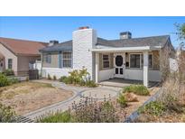 Charming front yard with landscaped features and an inviting entrance to a well-maintained two-story home at 636 H Ave, Boulder City, NV 89005
