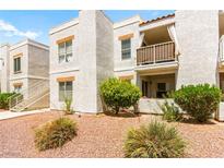 Attractive condominium complex with stucco exterior, balcony, and tidy landscaping at 6800 E Lake Mead Blvd # 1018, Las Vegas, NV 89156