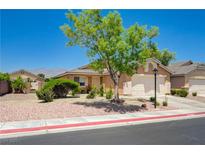 Charming single-story home with well-maintained landscaping, mature tree, and two-car garage at 7488 Evening Falls Dr, Las Vegas, NV 89131