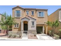 Two-story home showcasing an inviting entry and attached garage, complemented by manicured landscaping, exuding curb appeal at 9100 Hombard Ave, Las Vegas, NV 89148