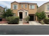 Charming two-story home featuring a quaint front porch and attached garage at 9100 Hombard Ave, Las Vegas, NV 89148