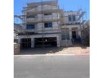 Unfinished two-story home featuring a spacious garage, stairs to the front door, and construction scaffolding at 10236 Rosemont Hills St, Las Vegas, NV 89141