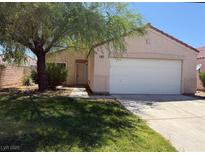 Charming single-story home with a well-maintained lawn and a mature shade tree in the front yard at 1041 Cedar Pines St, Henderson, NV 89011