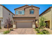 Charming two-story home with a two-car garage and desert landscaping in a sunny neighborhood at 10650 Dryades Ave, Las Vegas, NV 89166