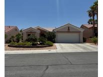 Charming single-story home with a two-car garage and lush desert landscaping at 10709 Heritage Hills Dr, Las Vegas, NV 89134