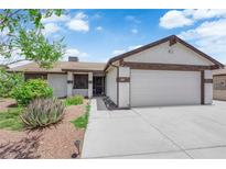 Charming single-story home with a well-maintained front yard and a two-car garage at 1105 Winwood St, Las Vegas, NV 89108