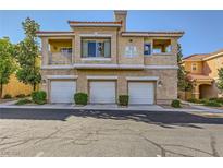 Three-story condo featuring garages and tan stucco finish at 251 S Green Valley Pkwy # 3222, Henderson, NV 89012