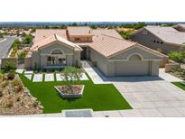 Beautiful single-story home with a well-manicured lawn, elegant landscaping, and a spacious two-car garage at 2616 Faiss Dr, Las Vegas, NV 89134
