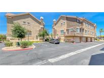 Contemporary condo featuring neutral paint, garage parking, mature trees, and well-maintained landscaping at 2766 Red Vista Ct, Henderson, NV 89074