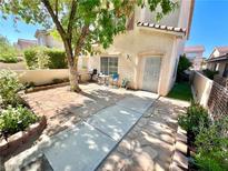 Cozy back patio area featuring stone pavers, a mature tree, and outdoor seating at 39 Belle La Blanc Ave, Las Vegas, NV 89123