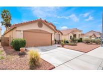 Charming single-story home featuring a two-car garage and tidy front yard landscaping at 5121 Backwoodsman Ave, Las Vegas, NV 89130