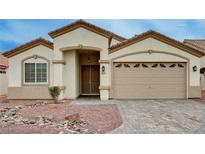Inviting single-story home showcasing a well-manicured yard and a neutral color palette at 525 Sun Mountain Ave, North Las Vegas, NV 89031