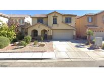 Charming two-story home with a well-manicured front yard and a two car garage, located in a tranquil suburban neighborhood at 5620 Siena Rose St, North Las Vegas, NV 89031
