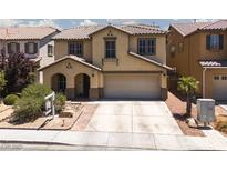 Charming two-story home with a desert landscape, two-car garage and tile roof in a residential neighborhood at 5620 Siena Rose St, North Las Vegas, NV 89031